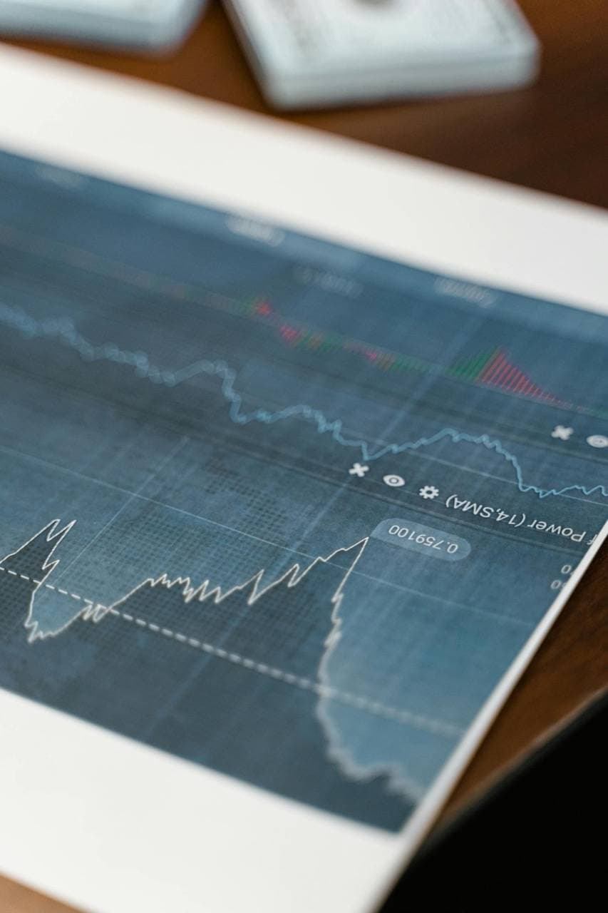 A printed financial report with line and bar charts on a desk.